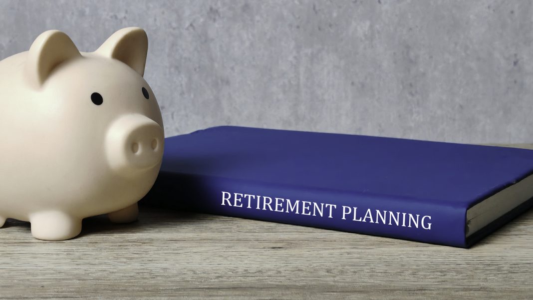 Comprehensive Retirement Planning with a piggy bank and a blue book labeled RETIREMENT PLANNING, emphasizing financial future and saving strategies.